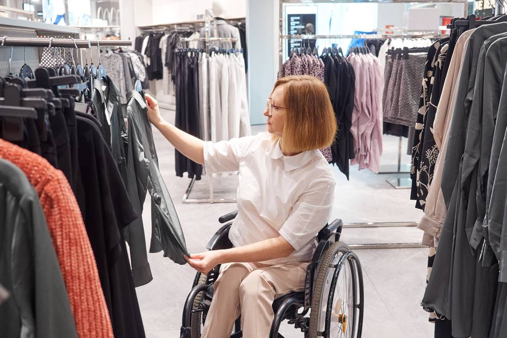 woman in a wheelchair shopping for adaptive clothes
