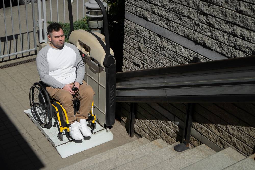 man is wheelchair using stair lift