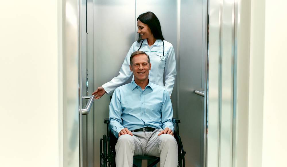 patient in a wheelchair entered the elevator with caregiver