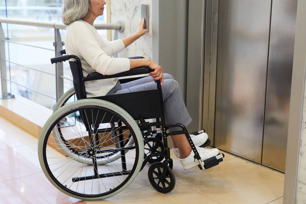 woman in wheelchair taking elevator